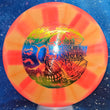 Load image into Gallery viewer, Top-down view of a pre-owned pink and orange 2023 Halloween Truly Unique stamped Dynamic Discs Justice midrange disc golf disc in Fuzion DyeMax plastic in 10 out of 10 uninked condition.
