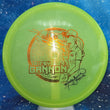 Load image into Gallery viewer, Top-down view of a pre-owned lime green Missy Gannon signed LSWT Dynamic Discs Justice midrange disc golf disc in Lucid Glimmer plastic scaled at 173g in 10 out of 10 uninked condition.

