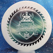 Load image into Gallery viewer, Top-down view of a pre-owned white Truly Unique 2017 Midwest Championship stamped Dynamic Discs Justice midrange disc golf disc in Fuzion DyeMax plastic scaled at 174g in 10 out of 10 uninked condition.
