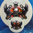 Load image into Gallery viewer, Top-down view of a pre-owned white 01 of 40 Zombie Trilogy Man stamped Dynamic Discs Justice midrange disc golf disc in Fuzion DyeMax plastic with mini scaled at 174g in 10 out of 10 uninked condition.
