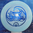 Load image into Gallery viewer, Top-down view of a pre-owned light blue Tina Oakley Whale Sak stamped Dynamic Discs Trespass distance driver disc golf disc in Hybrid plastic with blue foil stamp scaled at 169g in 10 out of 10 uninked condition.
