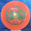 Load image into Gallery viewer, Top-down view of a pre-owned pink Tina Oakley Whale Sak stamped Dynamic Discs Trespass distance driver disc golf disc in Hybrid plastic with green foil stamp scaled at 174g in 10 out of 10 uninked condition.
