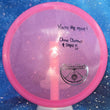 Load image into Gallery viewer, Top-down view of a pre-owned neon pink Chris Clemons Clemonade signed Dynamic Discs Verdict midrange disc golf disc in Lucid-X Glimmer plastic scaled at 177g in 10 out of 10 uninked condition.
