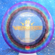 Load image into Gallery viewer, Top-down view of a pre-owned purple, yellow, and red dyed Dynamic Discs Verdict midrange disc golf disc in Lucid plastic scaled at 179g in 10 out of 10 uninked condition.
