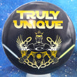 Load image into Gallery viewer, Top-down view of a pre-owned black and yellow Truly Unique custom printed Latitude 64 Claymore midrange disc golf disc in DyeMax Gold Line plastic scaled at 178g in 10 out of 10 uninked bag kept condition.
