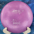 Load image into Gallery viewer, Top-down view of a purple Innova Star Wraith distance driver. The disc features a silver "Ken Climo 12 Time World Champion" signature stamp and a classic silver Innova logo. It is displayed on a white stand against a blue space-themed background.

