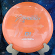 Load image into Gallery viewer, Top-down view of an orange Prodigy D1 distance driver disc golf disc in 500 Glimmer plastic with a silver and rainbow bubble foil Isaac Robinson 2x Worlds commemorative stamp.
