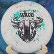 Load image into Gallery viewer, Top-down view of a green and black marbled Prodigy Waco midrange disc golf disc in 300 Fractal plastic featuring an oil slick and black dual-foil stamp.
