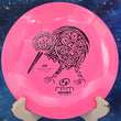 Load image into Gallery viewer, Top-down view of a pink RPM Discs Kiwi control driver disc golf disc in Atomic plastic featuring a black foil Māori Kiwi bird stamp.
