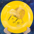 Load image into Gallery viewer, Top-down view of a yellow RPM Discs Kiwi control driver disc golf disc in Atomic plastic featuring a gold foil Māori Kiwi bird stamp.
