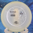 Load image into Gallery viewer, Top-down view of a Streamline Range putt and approach disc golf disc in Eclipse Glow plastic featuring a white, black, and blue holographic foil stock stamp.
