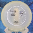 Load image into Gallery viewer, Top-down view of a Streamline Range putt and approach disc golf disc in Eclipse Glow plastic featuring a white, black, and purple holographic foil stock stamp.
