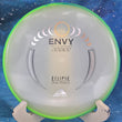 Load image into Gallery viewer, Top view of an Axiom Envy putter in Eclipse 2.0 Glow plastic featuring a Green-Lime Swirl GYRO rim and a Tri-Foil stock stamp, 173g, 10/10 condition.
