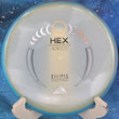 Load image into Gallery viewer, Top view of an Axiom Hex midrange disc in Eclipse Glow plastic featuring a Blue-Red Swirl GYRO rim and a Silver and Gold tri-foil stock stamp, 176g, 10/10 condition.

