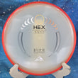 Load image into Gallery viewer, Top view of an Axiom Hex midrange disc in Eclipse Glow plastic featuring a Red-Orange Swirl GYRO rim and a Silver and Gold tri-foil stock stamp, 176g, 10/10 condition.
