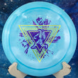 Load image into Gallery viewer, Blue swirl Discraft Nuke distance driver featuring a limited edition Throwing Astro two-foil stamp in purple and yellow
