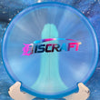 Load image into Gallery viewer, Translucent blue Discraft Zone approach disc in Z FLX plastic featuring a classic Discraft bar stamp with pink and blue foil.
