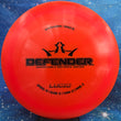 Load image into Gallery viewer, Orange Dynamic Discs Defender in Lucid plastic with a Black Matte foil stamp.
