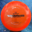 Load image into Gallery viewer, Neon Orange Dynamic Discs Trespass in Lucid plastic with a Silver Holo foil stamp.
