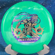 Load image into Gallery viewer, Top view of a Green and Lime Swirly Star Innova Philo Brathwaite Destroyer featuring a Gold Holo and Purple tri-foil tour stamp, 169g, 10/10 condition.
