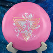 Load image into Gallery viewer, Top view of a Pink Innova Star Leopard disc featuring a Gold and White 2-foil "Neon Astro" Special Edition stamp on a cosmic blue background.
