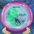 Load image into Gallery viewer, Purple and light blue Proto Glow Halo Star TL3, 2026 Iida Lehtomäki Champion Series tour stamp with green holo foil.
