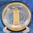 Load image into Gallery viewer, Top view of a Yellow MVP Photon distance driver in Proton plastic, featuring a Black tri-foil stock stamp, 174g, 10/10 condition.
