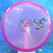 Load image into Gallery viewer, Pre-Owned Pink Lumen Glow C-Line Discmania MD1 with Huk Lab Trifly stamp - 8/10 Condition - 177g.

