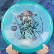 Load image into Gallery viewer, Top view of a Blue pre-owned Discmania MD3 Iron Samurai 3 (Eagle McMahon Signature Series) in Color Glow C-Line plastic, featuring a 2-foil character stamp.
