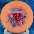 Load image into Gallery viewer, Top view of an Orange and Black marbled Prodigy PA5 understable putter in 300 Soft Fractal plastic featuring a Red and Orange Circles 2-foil "Throwing Astro" Special Edition astronaut stamp.
