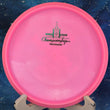 Load image into Gallery viewer, Close-up of the rim and plastic texture of a pre-owned pink Discmania Mutant. The Neo plastic is shown in high detail to highlight its 9/10 condition and lack of ink.
